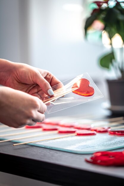 Packaging of red lollipops in the shape of hearts