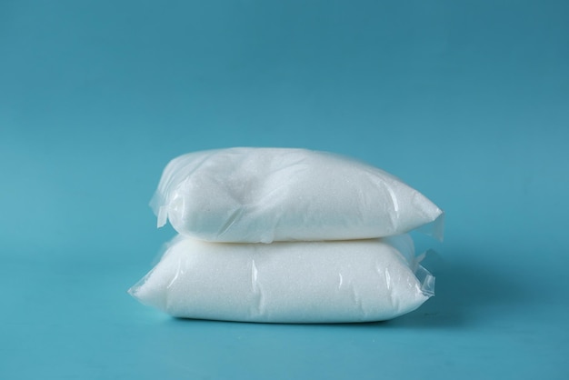 Packet of a white sugar on blue background