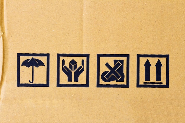 Packing caution symbol on brown paper