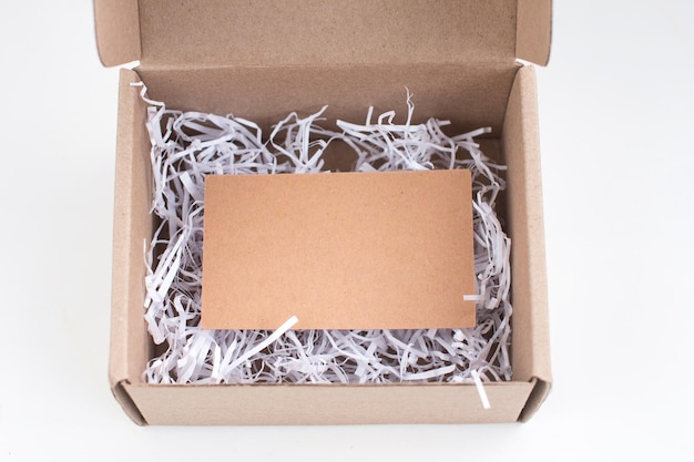 Packing kraft box with a business card inside Postal delivery gift registration