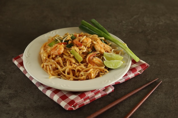 Pad thai is a stir-fried rice noodle dish commonly served as a Thailand street food.