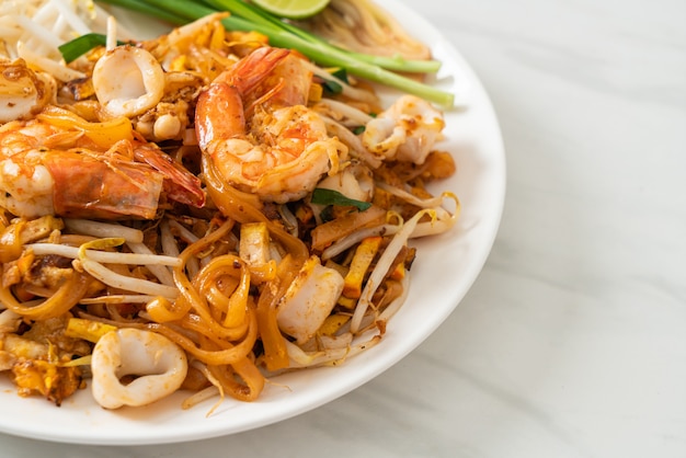 Pad Thai Seafood - Stir fried noodles with shrimps, squid or octopus and tofu in Thai style