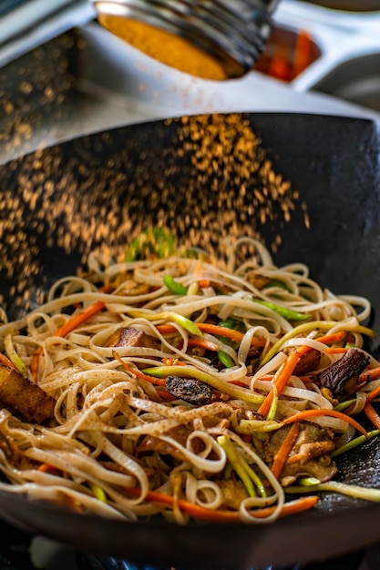 Pad thai. vegetarian dish in black dishes on a white background. a Thai dish.