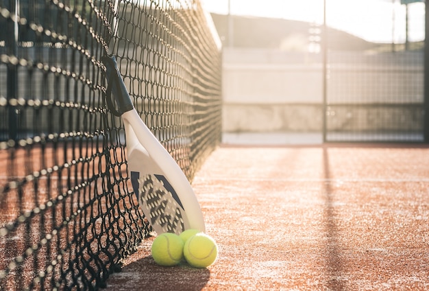 Padel blade racket resting on the net