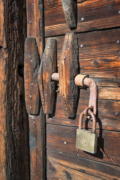 Padlock on antique wooden door