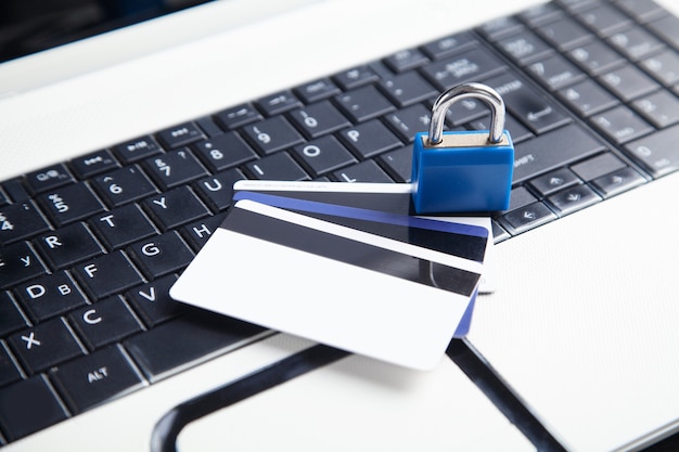 Padlock and credit cards on the computer keyboard. Credit card security