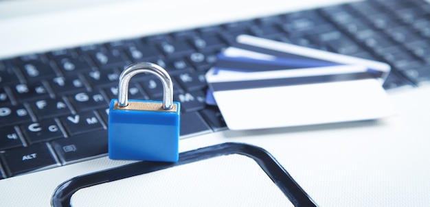 Padlock and credit cards on the computer keyboard. Credit card security