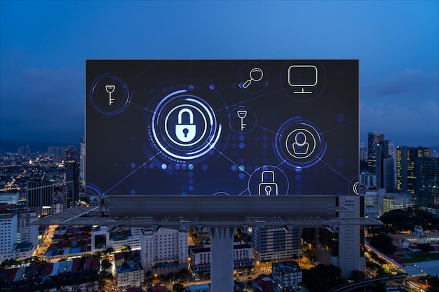 Padlock icon hologram on road billboard over panorama city view of Kuala Lumpur at night to protect business Malaysia Asia The concept of information security shields