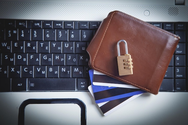 Padlock wallet and credit cards on the computer keyboard Credit card security