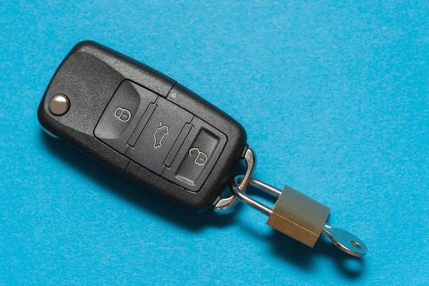 Padlock with key inside attached to a black car keys