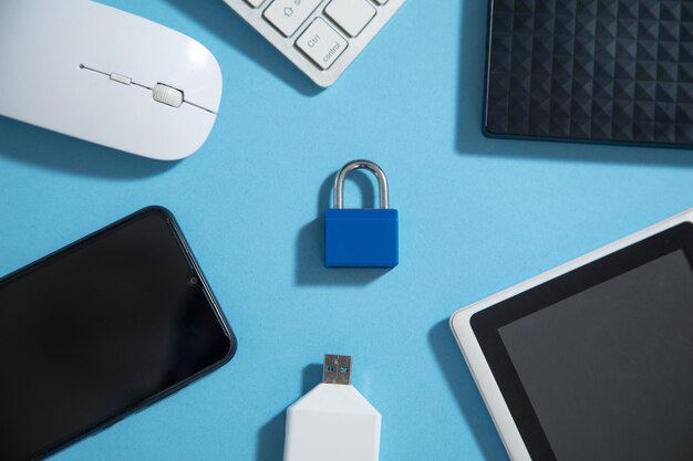 Padlock with a tablet keyboard mouse and other device Internet and technology security