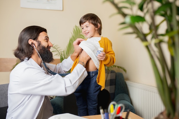 Paediatrician doctor examining a child in comfortabe medical office