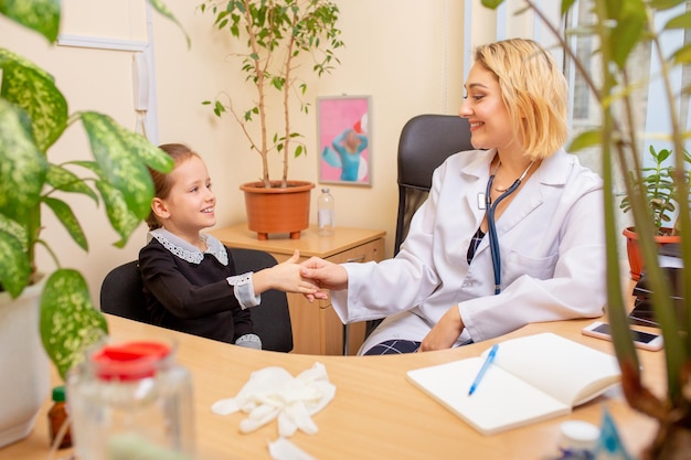 Paediatrician doctor examining a child in comfortabe medical office