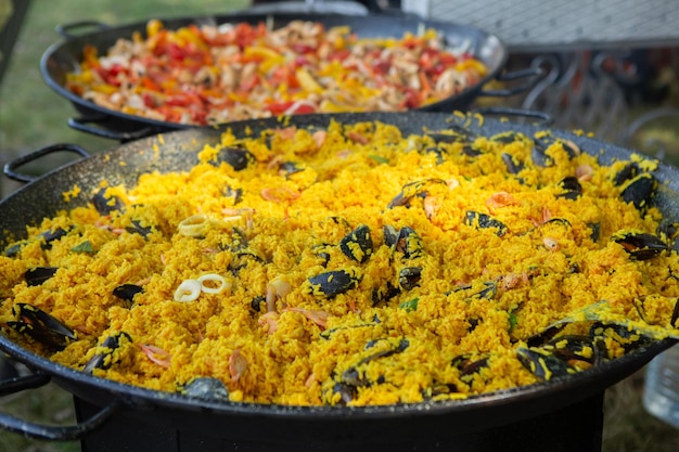 Paella traditional Spanish food. paella prepared on a large pan on the street on fire