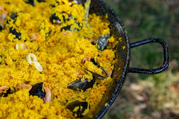 Paella traditional Spanish food. paella prepared on a large pan on the street on fire