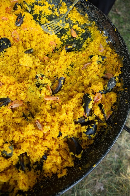 Paella traditional Spanish food. paella prepared on a large pan on the street on fire