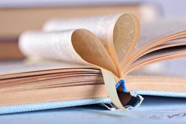 Pages of book curved into heart shape, close up