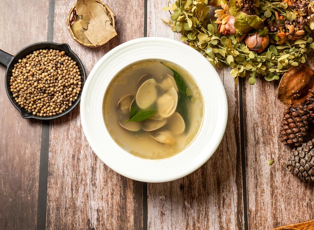 pagoda soup or calm soup with spoon and fork served in broth isolated on wooden table top view of taiwan fasfood