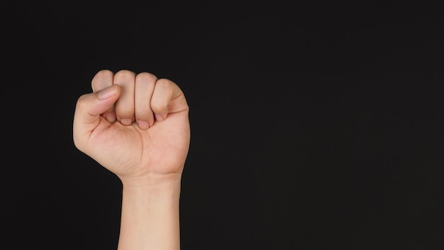 Pain hand sign or gesture on black background