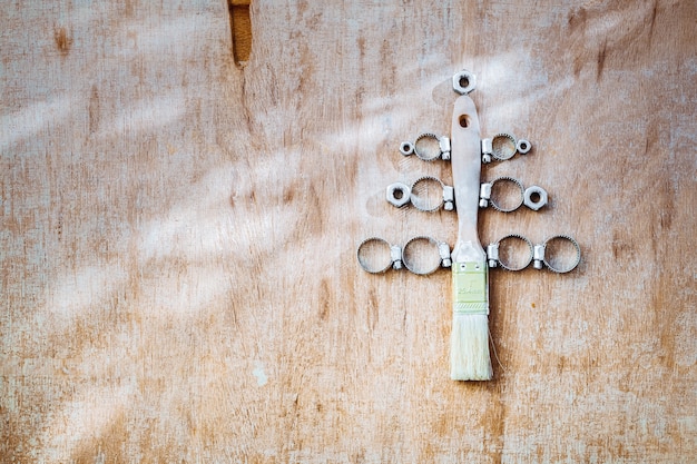 Paint brush and nuts and bolts decorated as christmas tree