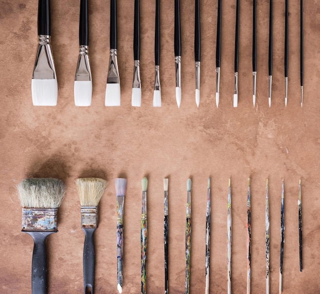 Paint brush on old parchment paper vintage aged or texture background