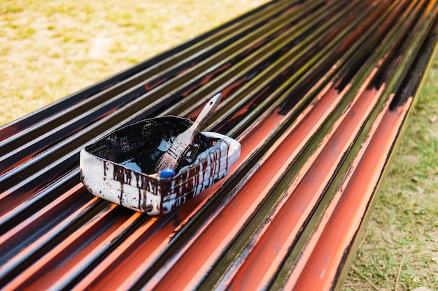 Paint brush on paint bucket for paint steel tape for protect rust.