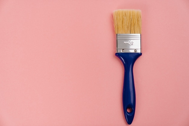 Paint brush on a pink background. tools for painting and repair work.