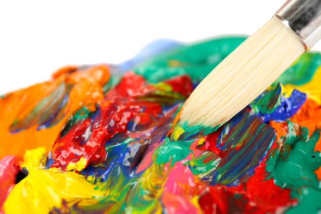 Paint brush with colorful paints close up