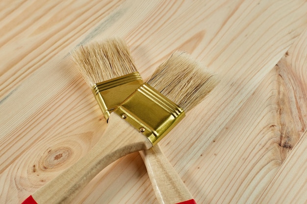 Paint brushes on a wooden board View from above Flat lay