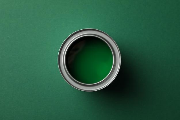 Paint can on green surface