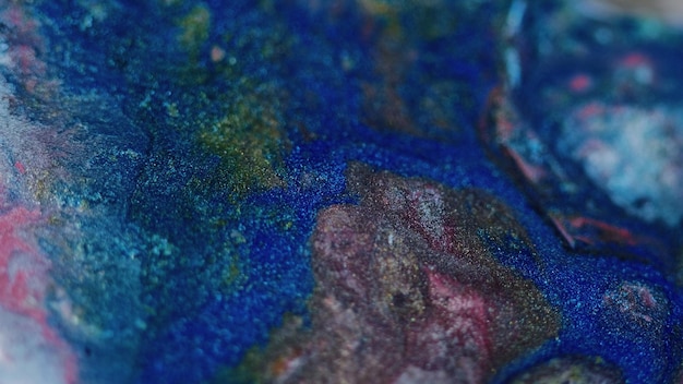 Paint spill glitter ink flow defocused blue pink black color sparkling metallic liquid pouring blend