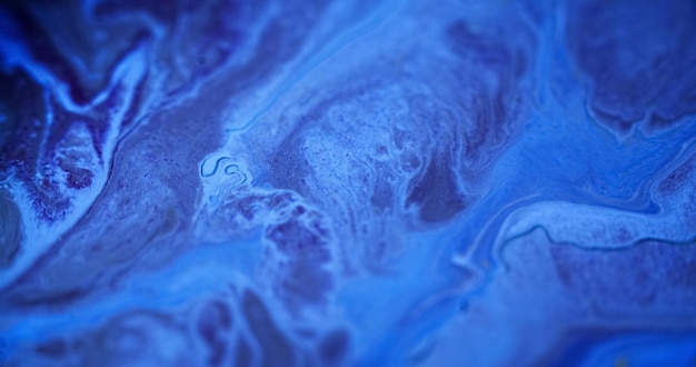 Paint splash wet marble defocused blue color glowing shimmering particles texture acrylic fluid