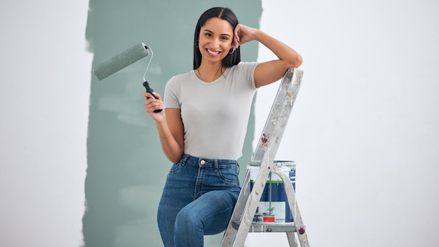 Paint wall and woman with color choice in portrait for home renovation room interior or creative hardware project inspiration Happy woman painter on ladder for painting with mock up marketing