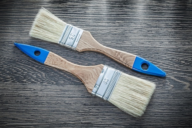 Paintbrushes on wooden board top view