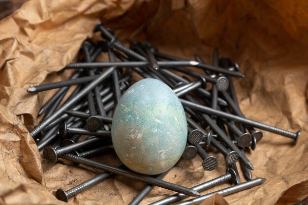 Painted Easter eggs on paper with nails