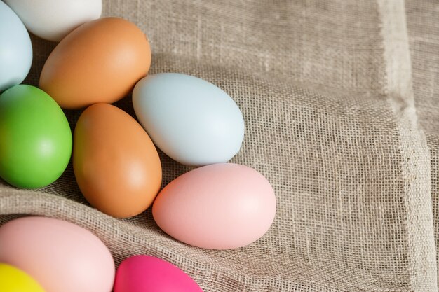 Painted Easter eggs on sackcloth, rustic festive composition