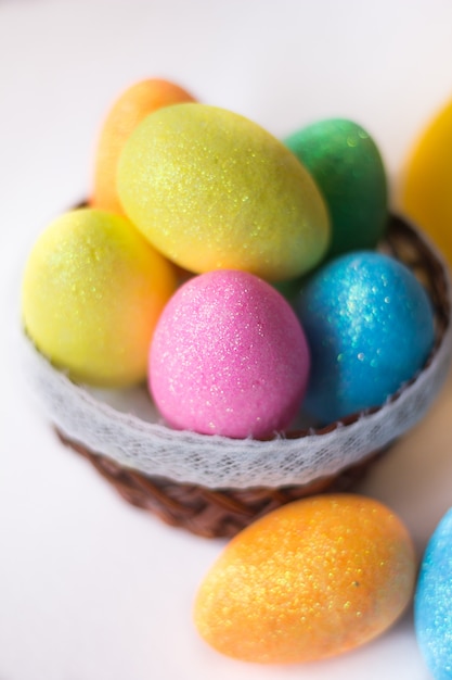 Painted eggs in basket isolated on white backround. . Happy easter