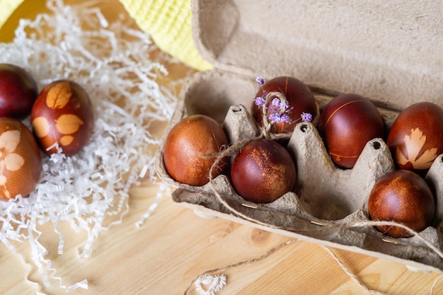 Painted eggs cooked for Easter are in an ecofriendly tray on the table