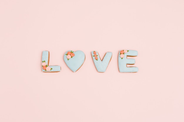 Painted gingerbread in shape of word love.  for Valentines Day, wedding. Love romance concept. Top view with space for your text.