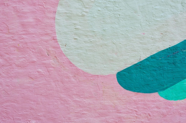 Painted pink rough cement wall with semicircles figures