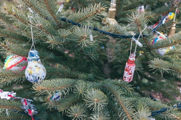 Painted red and blue old electric light bulb on Christmas tree DIY decoration