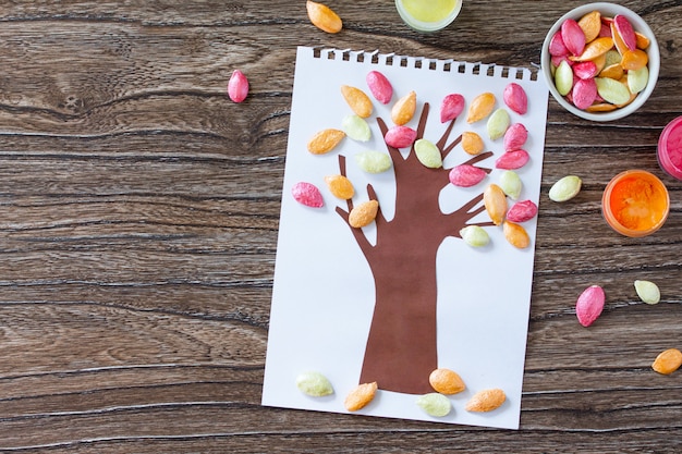 Painted tree with leaves from pumpkin seeds