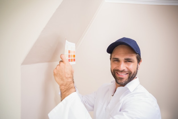 Painter consulting a colour chart