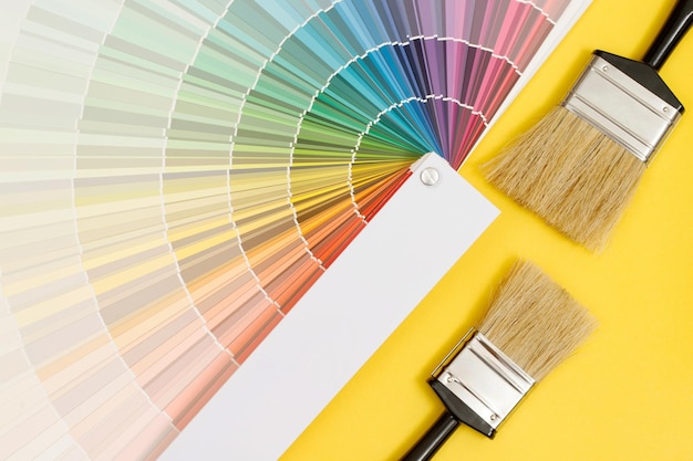 A painter is choosing a paint shade for the interior of the house's walls with interior