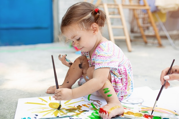 Painting at the backyard with paper, water color and art brush.