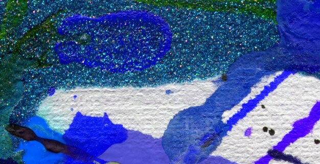 A painting of blue and green glitter with the word love on it.