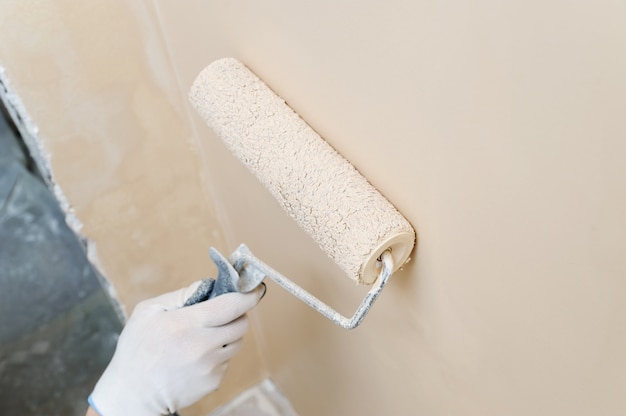 Painting roller in a man's hand.