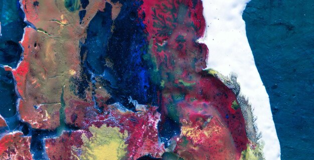 A painting of a woman's face is covered in red, blue, and yellow colors.