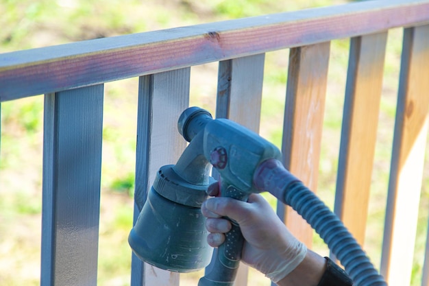 Painting a wooden board with a gray spray Selective focus