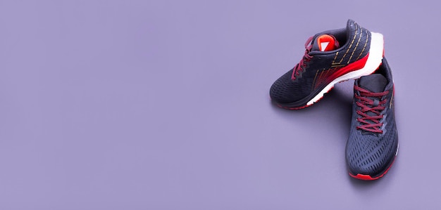 A pair of black and red sneakers on a dark background The concept of a healthy lifestyle Banner with copy space